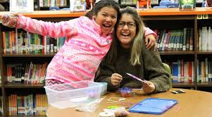 Lady and student in library